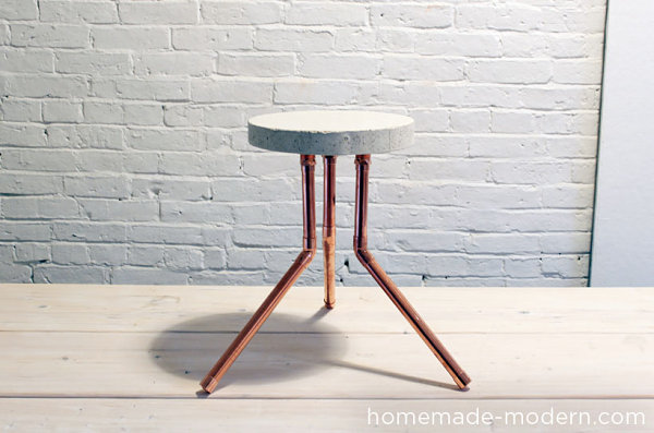 Stool made from concrete and piping