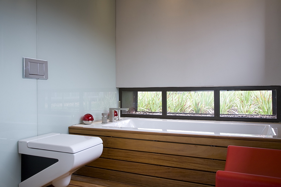 Stylish bathroom in white with red and wooden accents