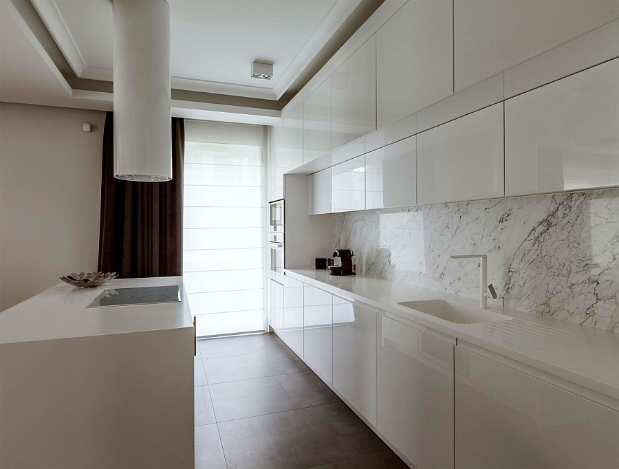 Super sleek modern kitchen in white with a marble backsplash