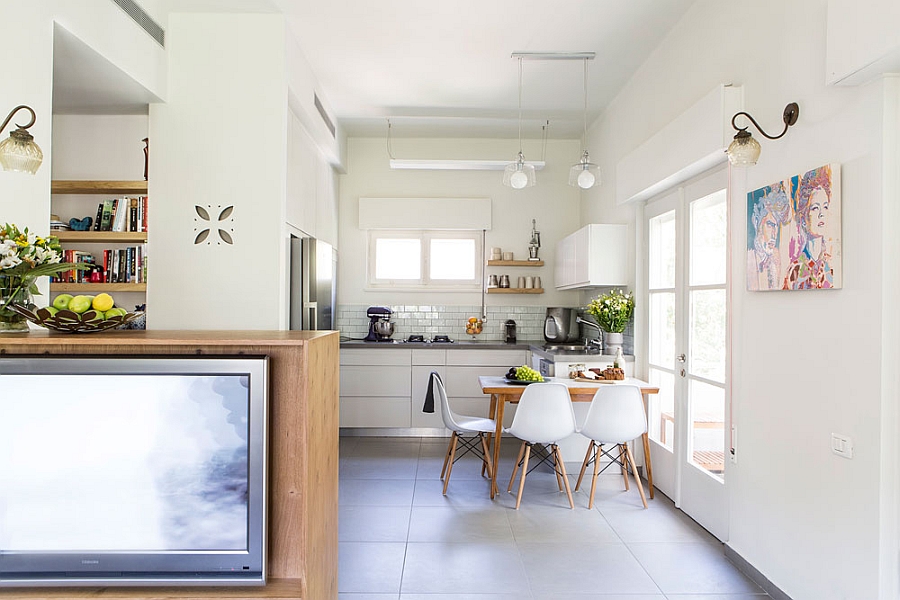 View of the cozy kitchen and the small dining room from the living space