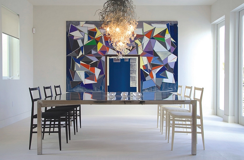 Wall art and chandelier enliven the minimal dining room