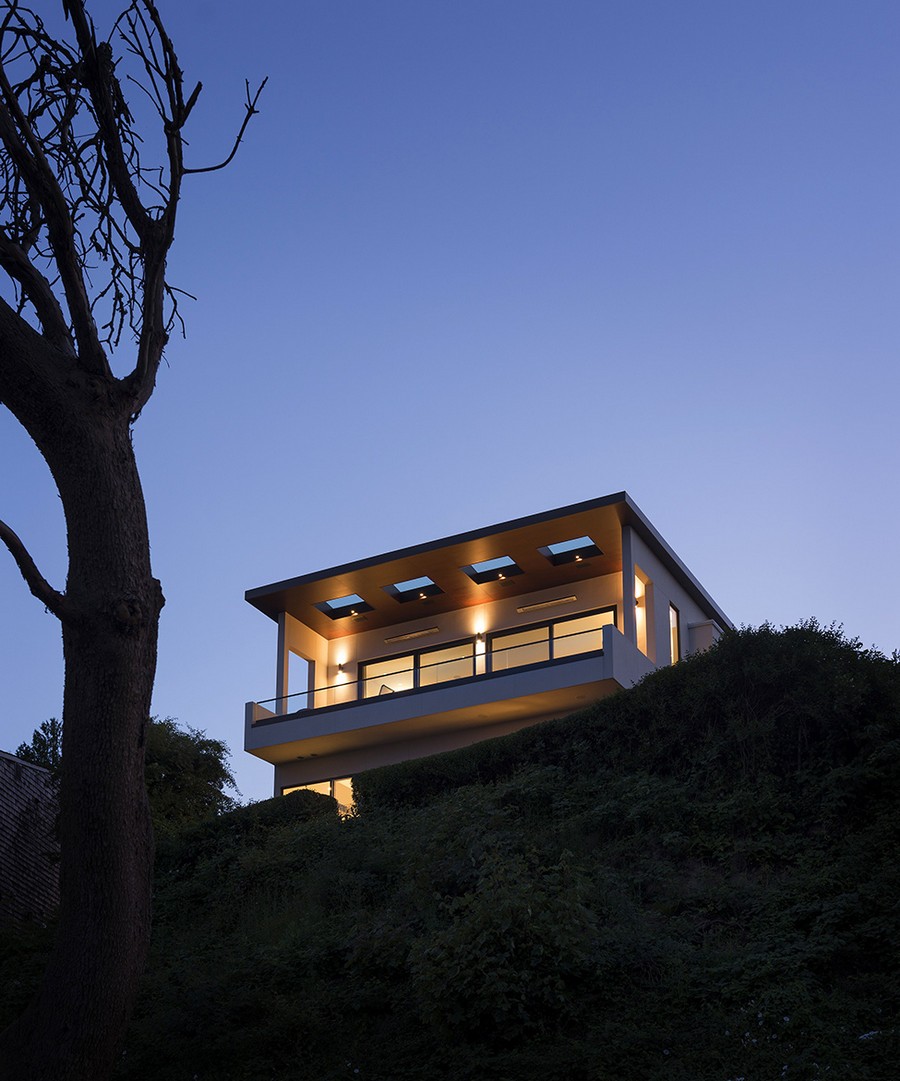 Warm lighting helps define facade of the modern home