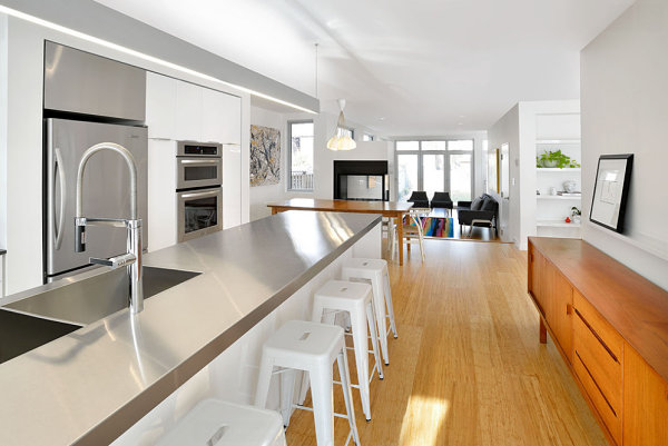 Wooden accents in a white kitchen with stainless steel cabinets