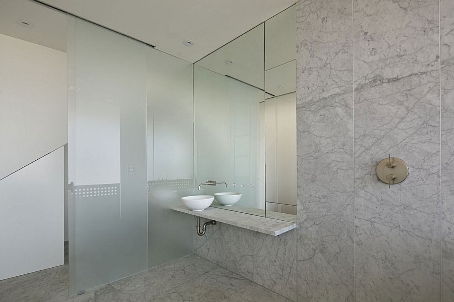 A minimal bathroom with frosted glass doors