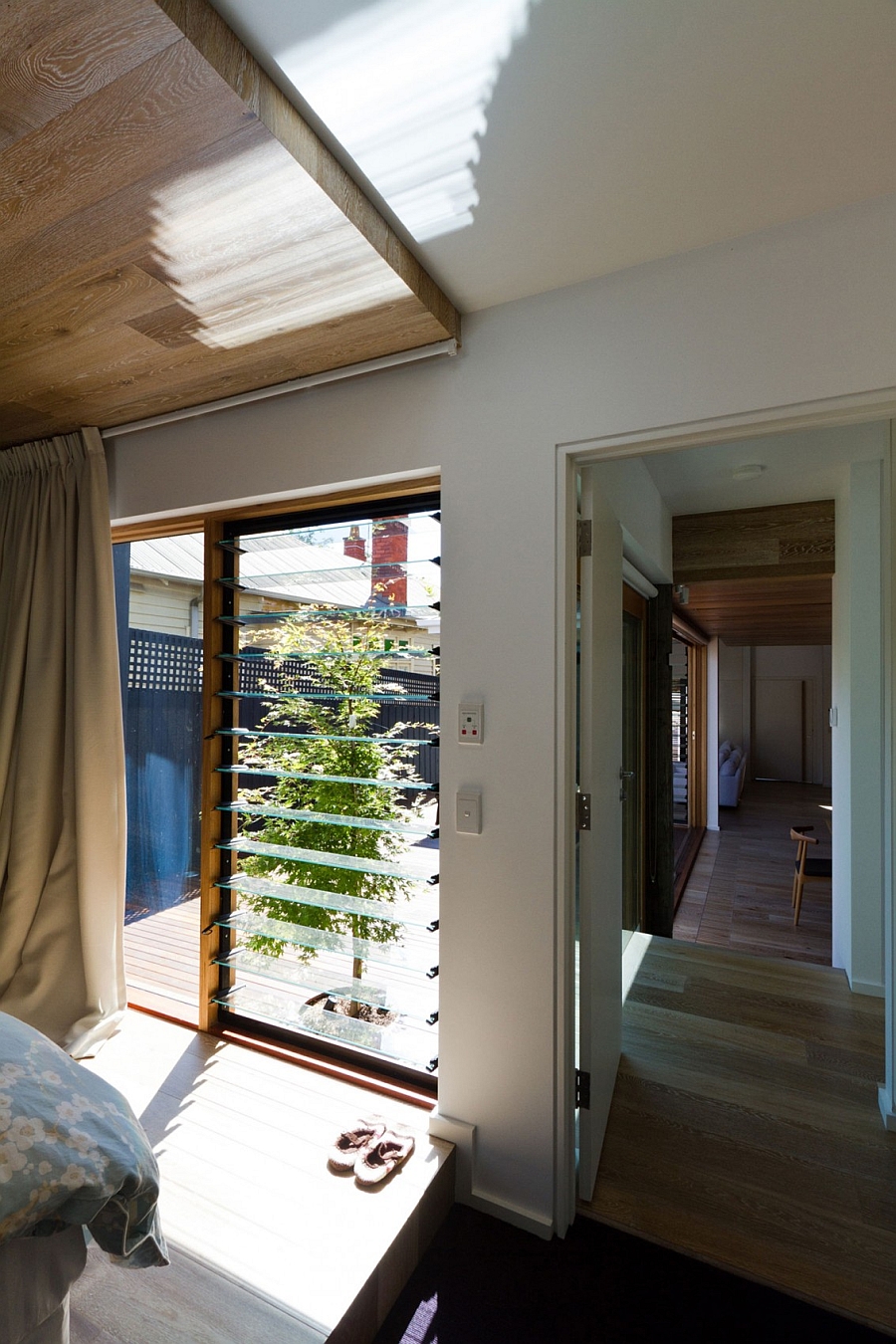 Bedroom of the Open House connected with the deck space outside