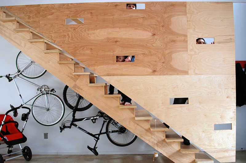 Bike rack uses the space under the unique flight of plywood stairs to the hilt