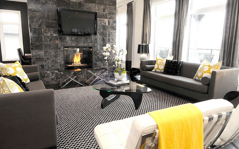 Black and white interior with yellow accents and TV mounted above the fireplace