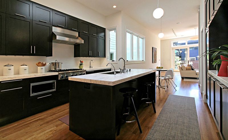 Black cabinets and white marble countertop in the kitchen