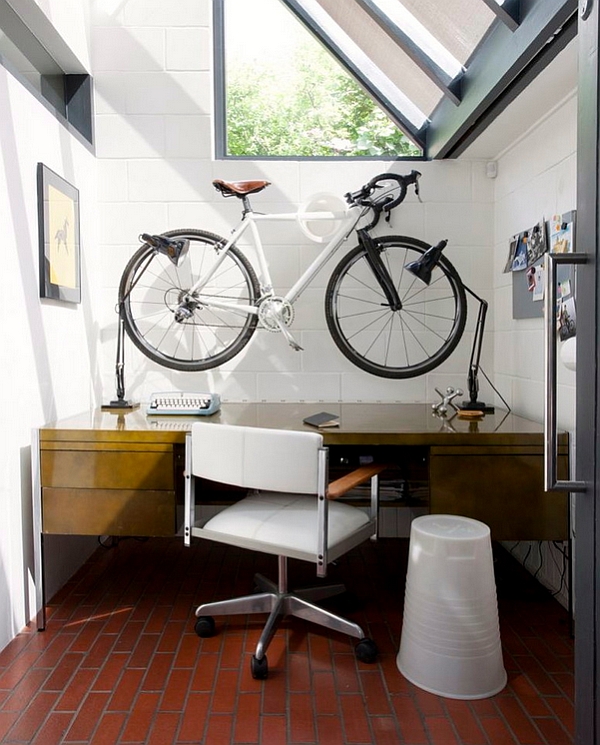 Compact home office with a wall-mounted bike above the desk!