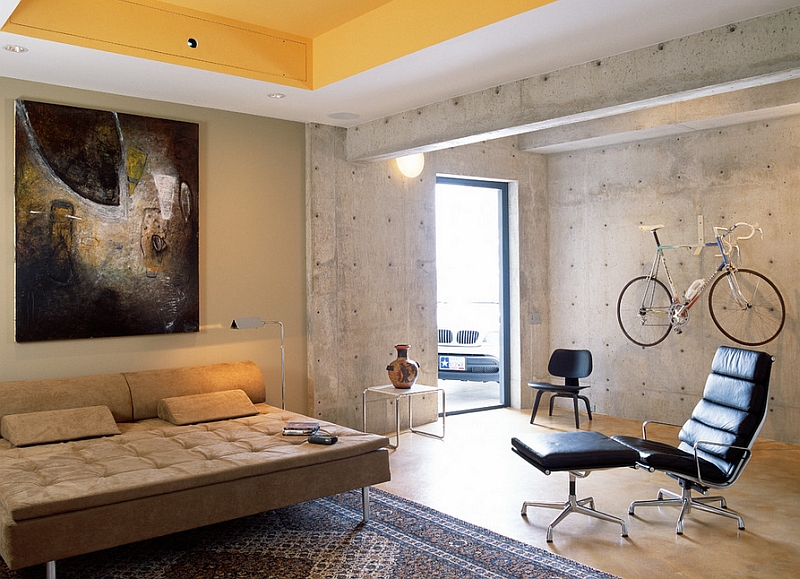 Concrete walls and the wall-mounted bicycle give the room an industrial edge