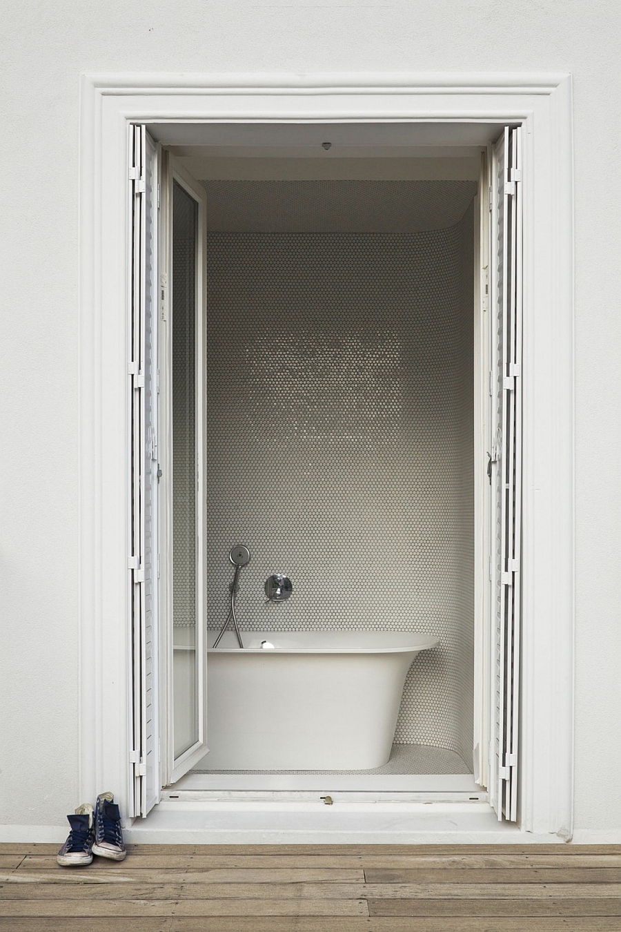 Contemporary bath with penny tiles on the walls and standalone bathtub