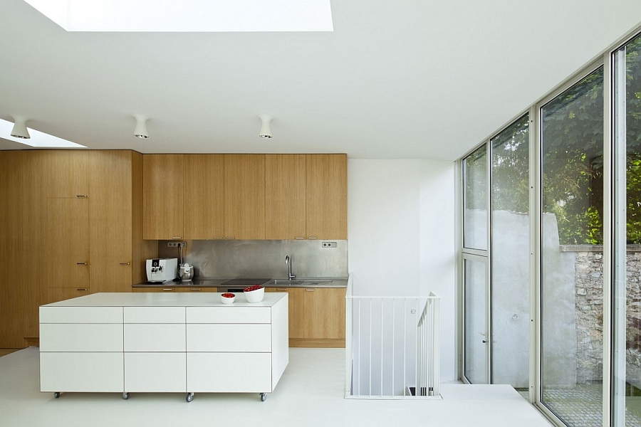 Contemporary kitchen with wooden cabinets and a white island on wheels