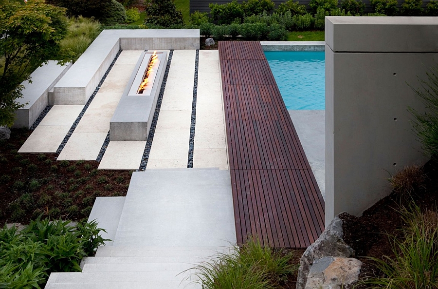 Contemporary outdoor fireplace next to the pool