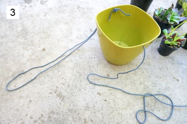 Form loops with the string on either side of the planter