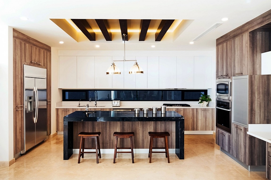 Gorgeous modern kiitchen with white cabinets and an island in black stone