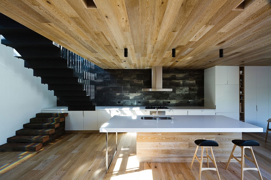 Kitchen with white shelves and corain countertop and a wooden island