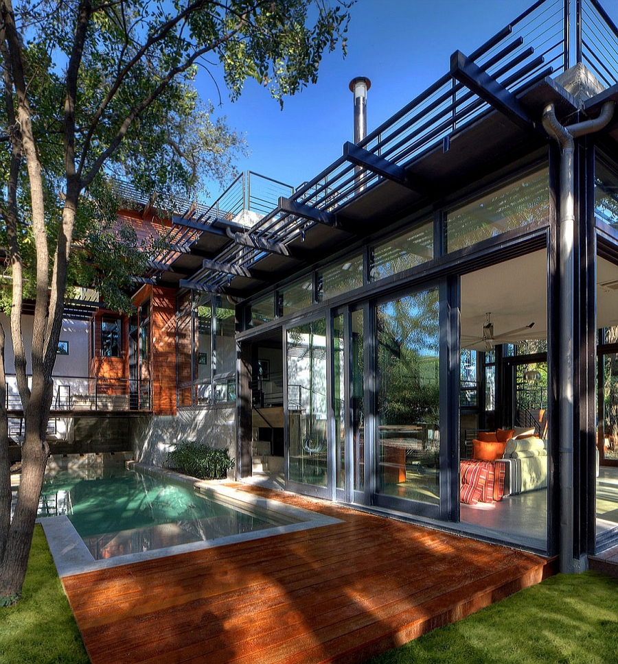 Large sliding glass doors connect the interior with the pool