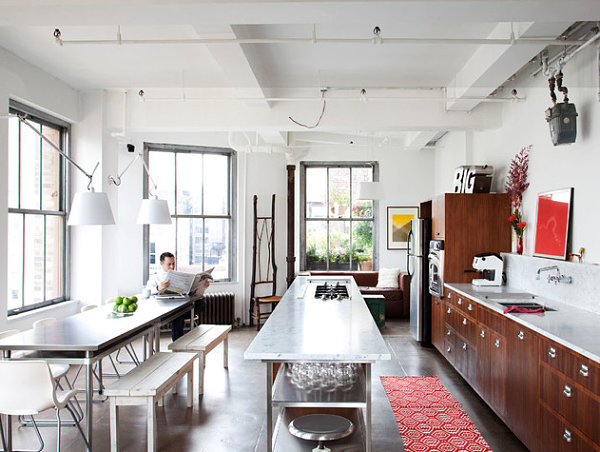 Long stainless steel kitchen island with a marble top