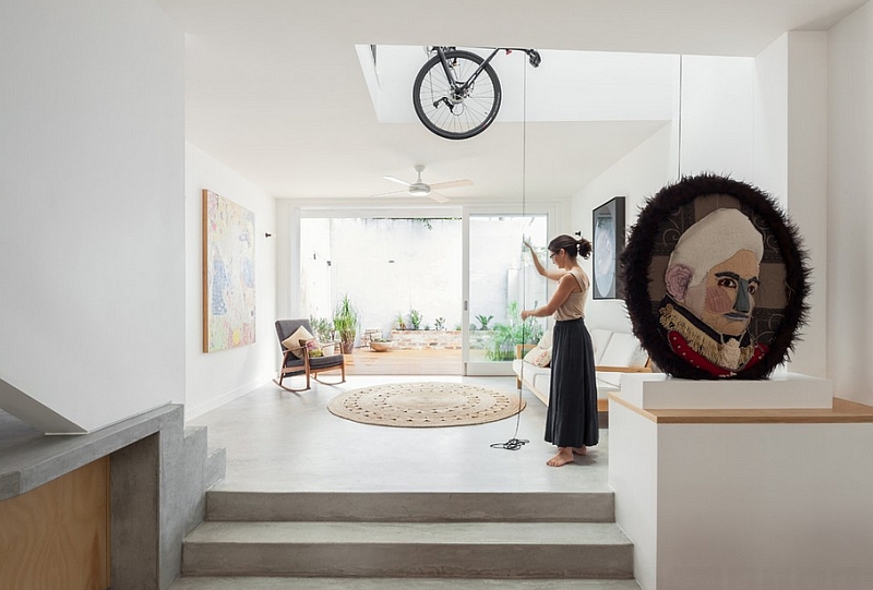 Modern home with the bikes hanging from the ceiling in a double height void