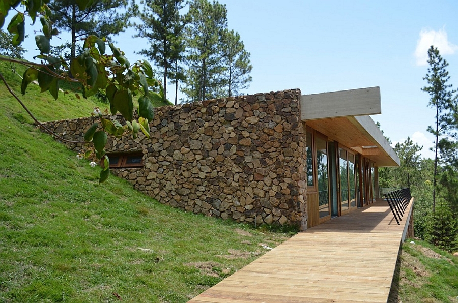 Natural materials like stone and wood shape the exterior