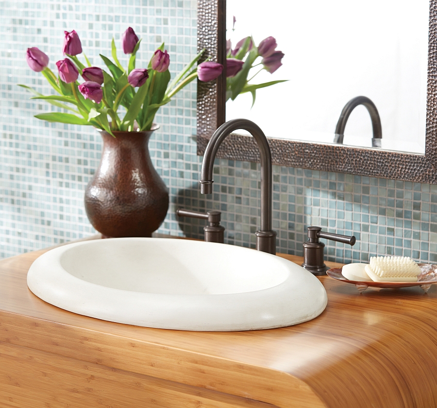 Oval shaped sink in white on a wooden vanity