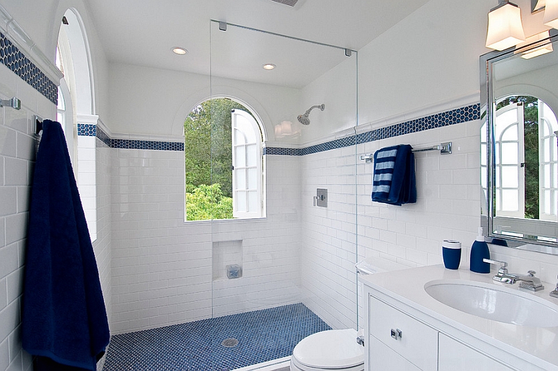 Penny tile floor in the shower area and accent towels bring the blue to the bathroom