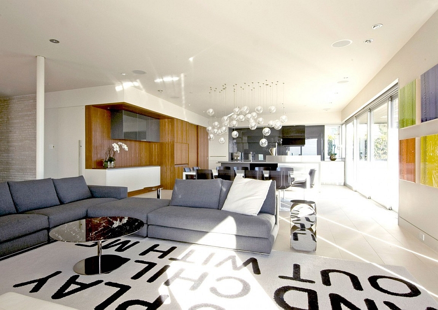 Plush blue-grey couch and wooden accents brighten the interior