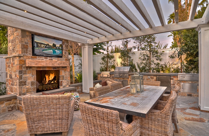 Relaxing outdoor space with a TV above the fireplace