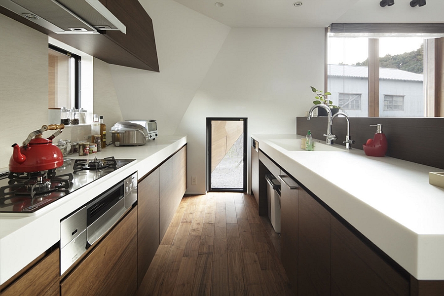 Sleek modern kitchen with white countertops and wooden cabinets