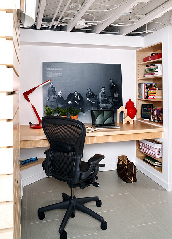 Small basement home office with a built-in desk and smart wall shelves