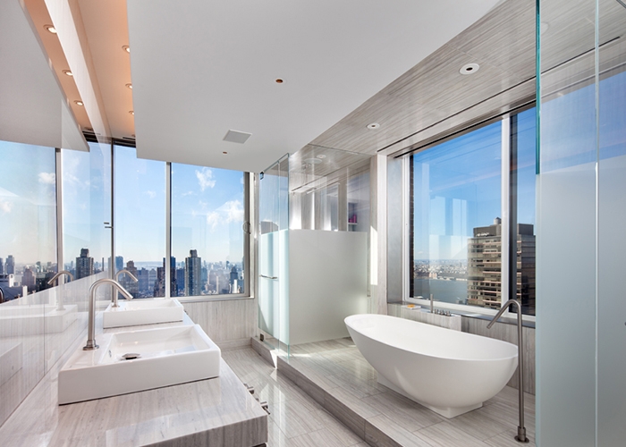 Spa-like contemporary bath in white with NYC skyline views