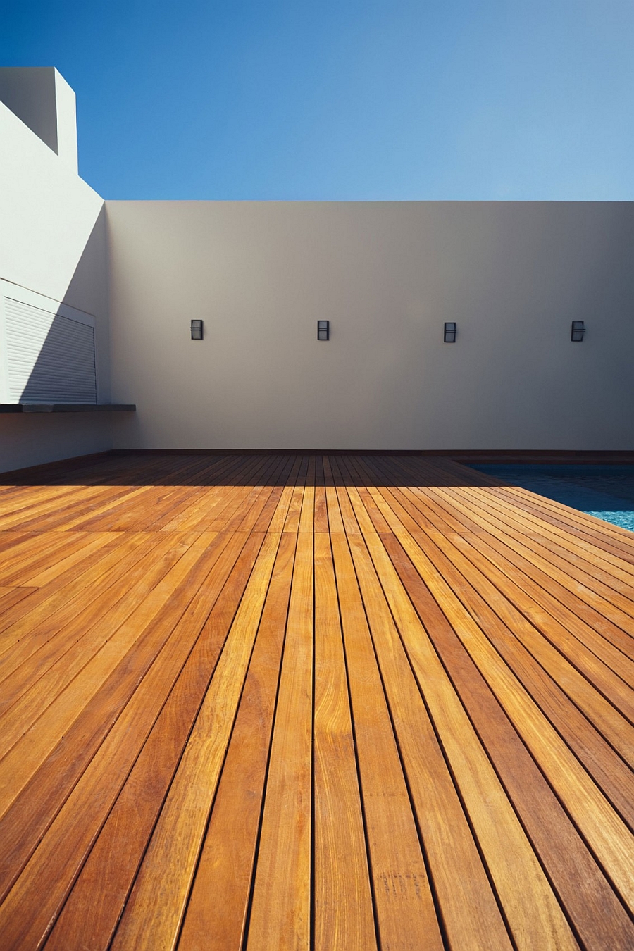 Spacious wooden deck next to the pool