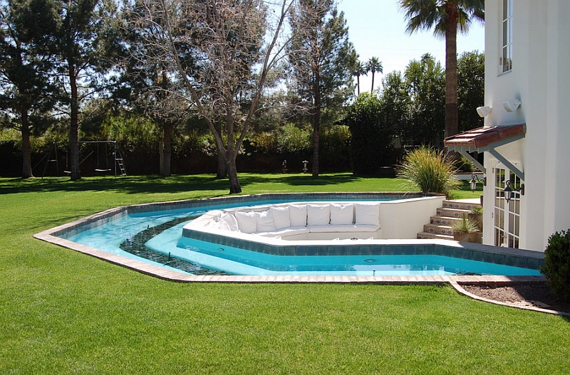 Sunken seating surrounded by the pool in the backyard