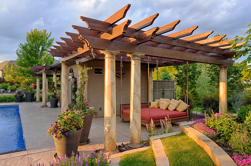 Suspended outdoor bed inside a pergola next to the pool