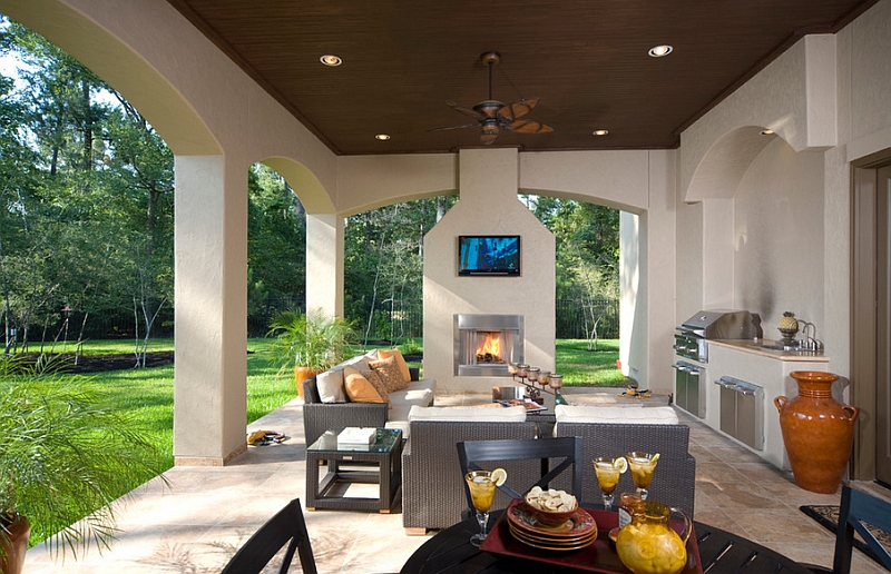 TV above fireplace in the patio is a feature that saves up on space