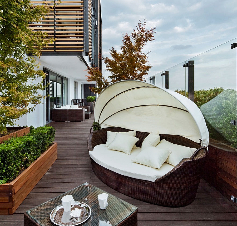 Trendy daybed on the deck of stylish Warsaw apartment