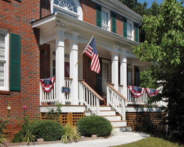 4th of July banner and flag on a front porch