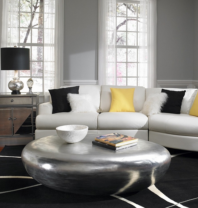 Amazing coffee table and black decor accentuate the gray and yellow touches in the room