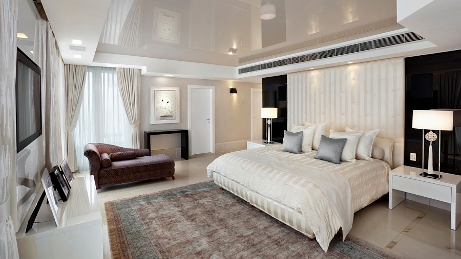 Beautiful contemporary bedroom in black and white with a headboard that extends up to the ceiling