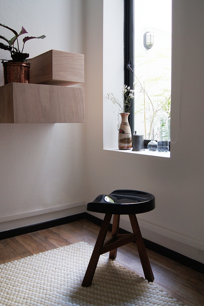 Beautiful felt ball rugs add visual warmth to the room