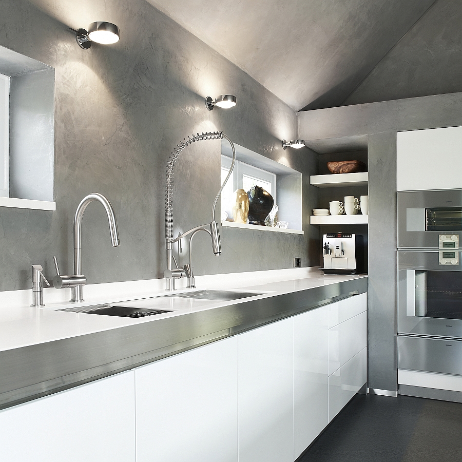 Beautiful modern kitchen with white cabinets, stainless steel faucets and countertop