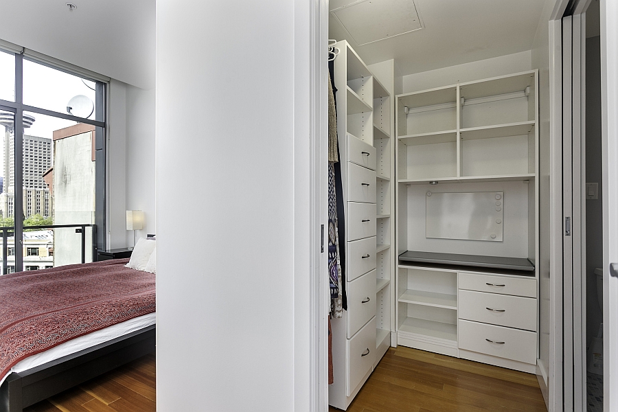 Bedroom with a walk-in closet next to it in the compact apartment