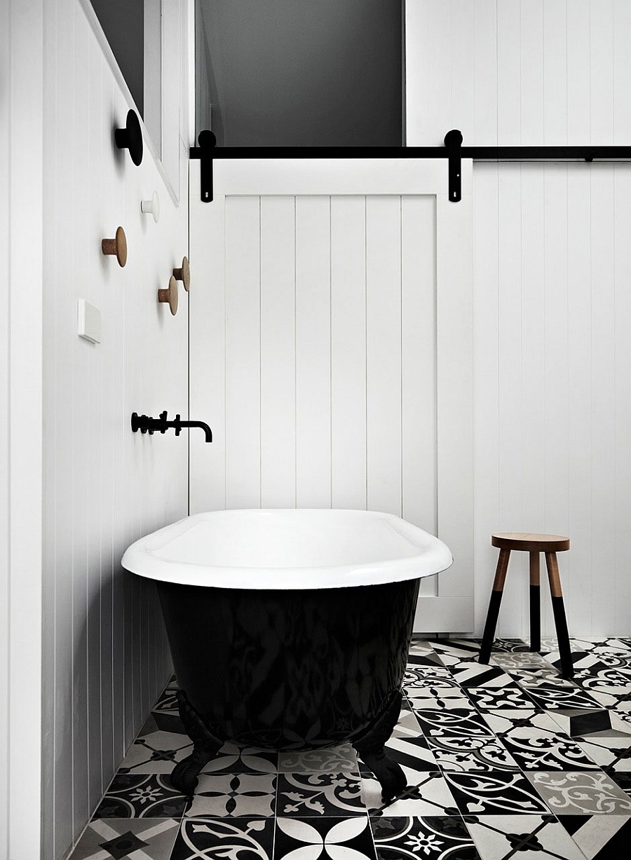 Black standalone claw-foot bathtub in the chic black and white bath