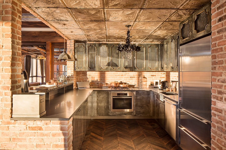 Chevron floors, exposed brick walls and vintage cabinets in the kitchen