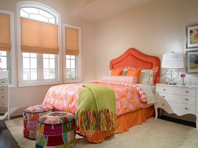 Colorful ottomans at the end of the bed give the room a Bohemian touch