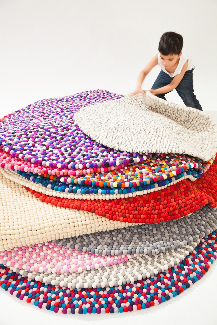 Colorful pile of felt ball rugs crafted from the finest wool