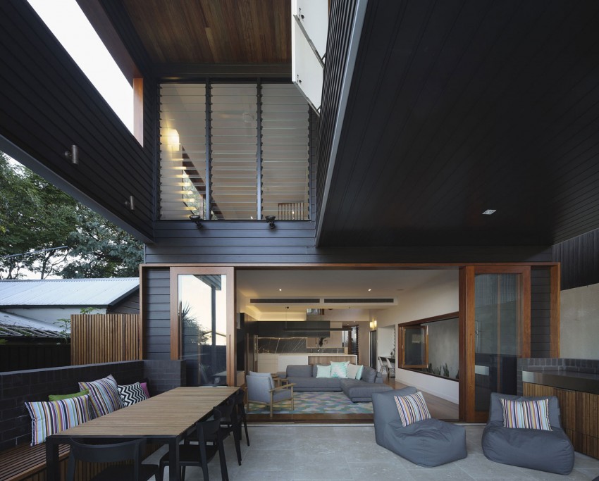 Cool outdoor lounge gets ample shade thanks to the upper level of the house