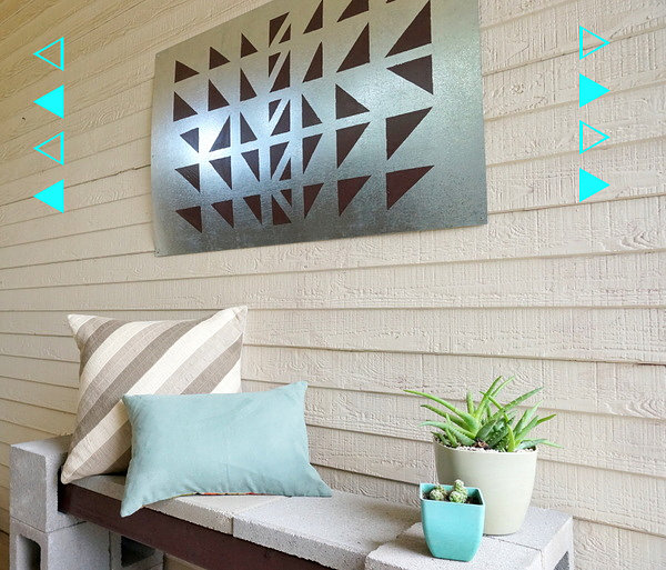 DIY outdoor wall art with a cinderblock bench