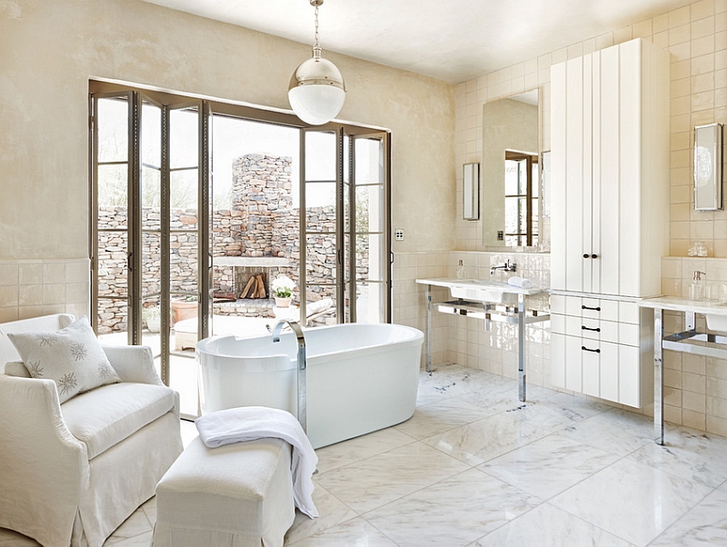 Exquisite modern bathroom with a large Hicks Pendant above the standalone tub