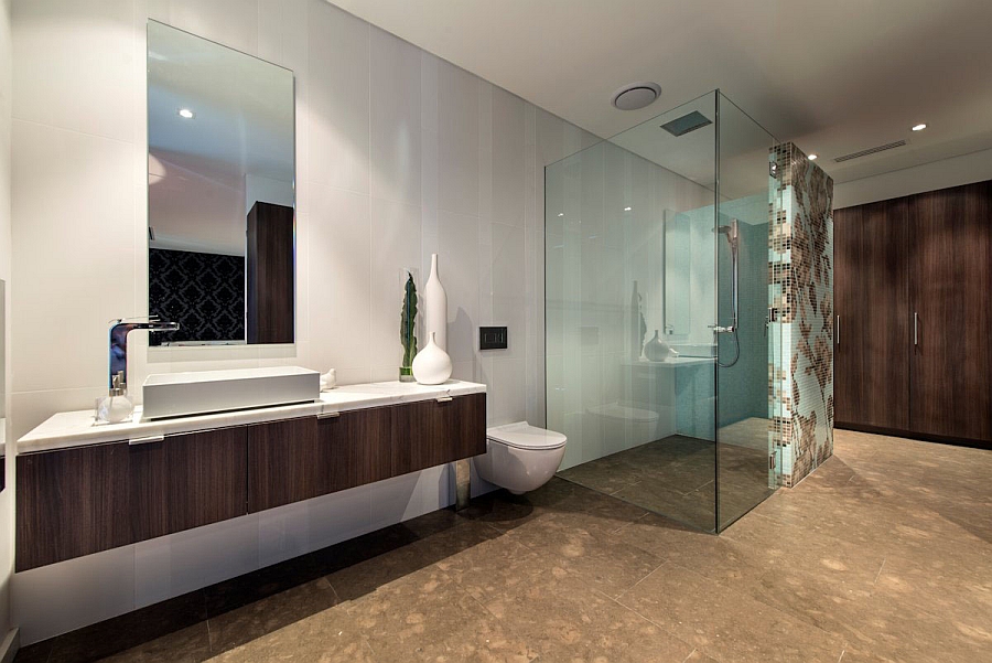 Glass shower area lends visual lightness to the bathroom